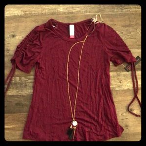 Maroon shirt with necklace